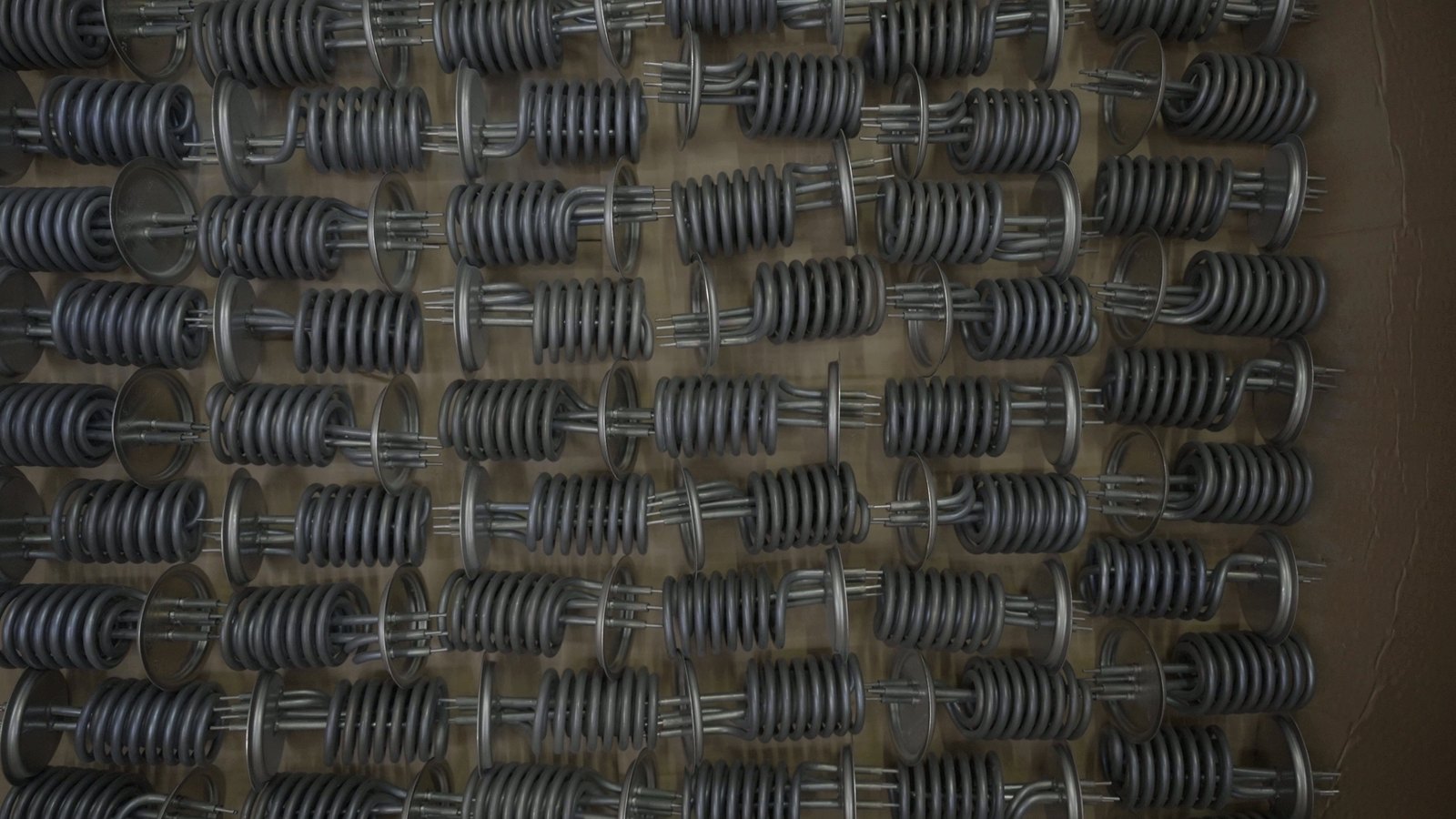 Coiled flange water-heater elements on a display board