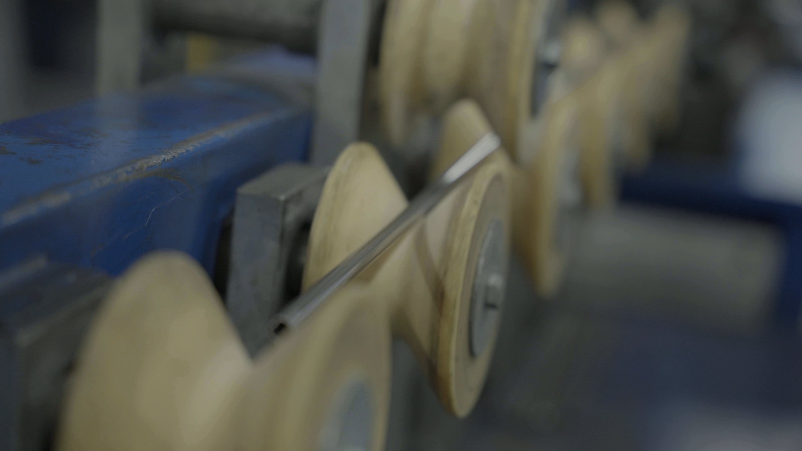 Welded stainless tube running over white guide rollers