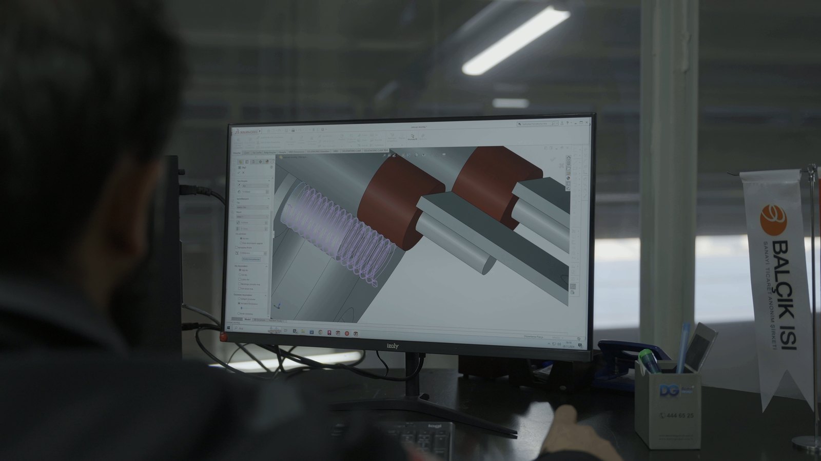 Engineer designing a heating element at a CAD workstation